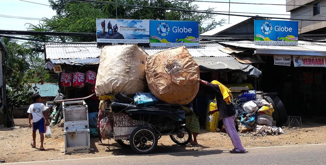 A heavily loaded tricycle in the Philippines