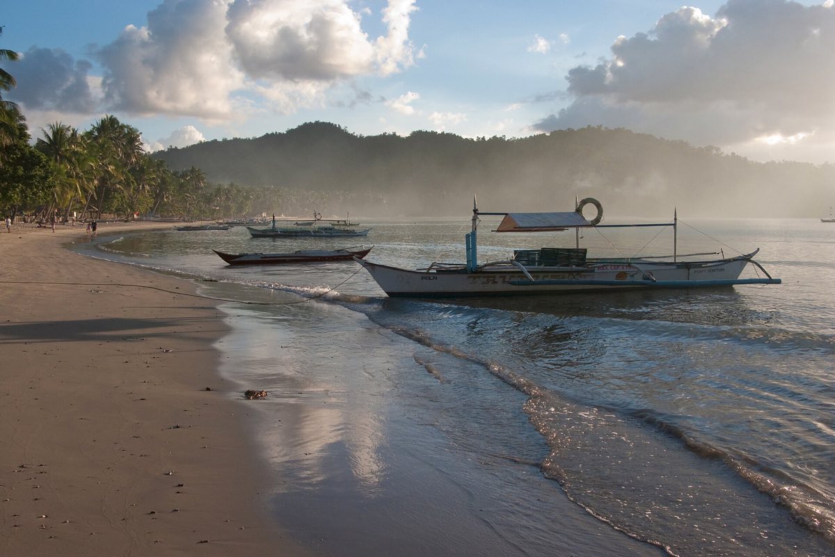 Outrigger boats drawn up at Port Barton, Palawan
